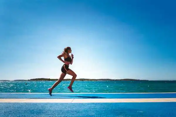 Woman running showing strong leg muscle Birchfield